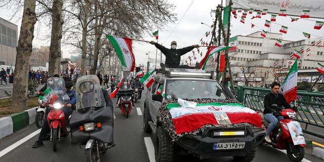 Feb. 11, 2022: People parade with Iran's flags during the annual rally commemorating anniversary of1979 Islamic Revolution in Azadi (freedom) Square in Tehran, Iran. (AP Photo/Vahid Salemi)