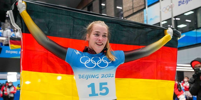 Hannah Neise, of Germany, celebrate winning the gold medal in the women's skeleton at the 2022 Winter Olympics, Saturday, Feb. 12, 2022, in the Yanqing district of Beijing.