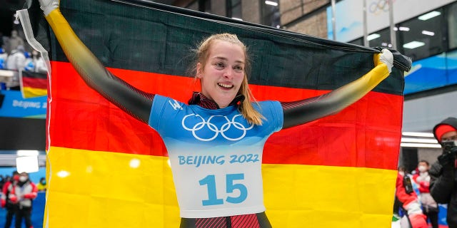 Hannah Neise, of Germany, celebrate winning the gold medal in the women's skeleton at the 2022 Winter Olympics, Saturday, Feb. 12, 2022, in the Yanqing district of Beijing.