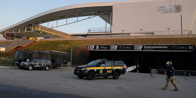 FILE - Police stand guard outside Neo Quimica Arena stadium after a qualifying soccer match between Argentina and Brazil for the FIFA World Cup Qatar 2022 was interrupted by health authorities in Sao Paulo, ブラジル, 9月. 5, 2021. FIFA announced on Feb. 14, 2022 that it handed out fines and suspensions to players while ordering Argentina and Brazil to play the World Cup qualifier again that was abandoned when after Brazilian health officials stormed the field to question the quarantine status of Argentines.  (AP Photo/Andre Peファイル, File)