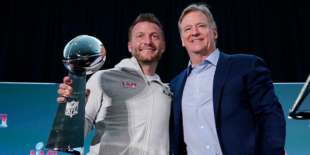 Los Angeles Rams head coach Sean McVay, left, holds the Vince Lombardi trophy during a press conference while posing for photos with league commissioner Roger Goodell following the NFL football team's Super Bowl win over the Cincinnati Bengals Monday, Feb. 14, 2022, in Los Angeles.