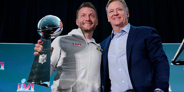 Los Angeles Rams head coach Sean McVay, left, holds the Vince Lombardi trophy during a press conference while posing for photos with league commissioner Roger Goodell following the NFL football team's Super Bowl win over the Cincinnati Bengals Monday, Feb. 14, 2022, in Los Angeles.