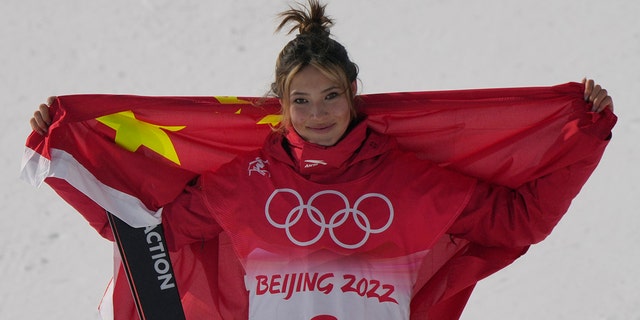 Silver medal winner China's Eileen Gu celebrates during the venue award ceremony for the women's slopestyle finals at the 2022 Winter Olympics, Tuesday, Feb. 15, 2022, in Zhangjiakou, China. 