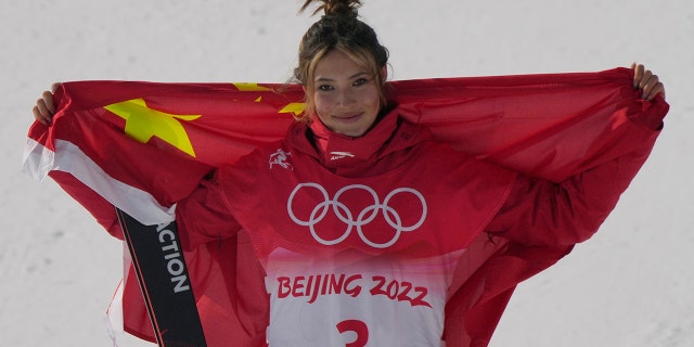Silver medal winner China's Eileen Gu celebrates during the venue award ceremony for the women's slopestyle finals at the 2022 Winter Olympics, Tuesday, Feb. 15, 2022, in Zhangjiakou, China.