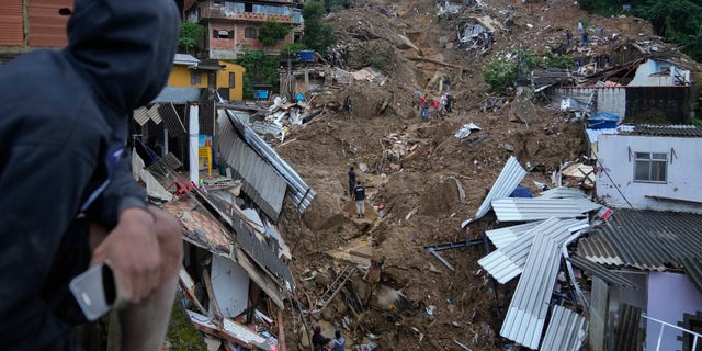 Rescue workers and residents search for victims in an area affected by landslides in Petropolis, Brazil, Wednesday, Feb. 16, 2022.