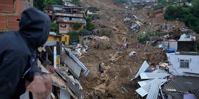 Rescue workers and residents search for victims in an area affected by landslides in Petropolis, Brazil, Wednesday, Feb. 16, 2022.