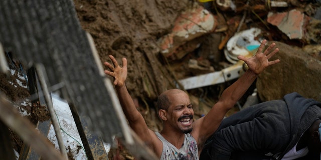 A resident yells during the search for survivors after fatal mudslides in Petropolis, Brazil, Wednesday, Feb. 16, 2022.