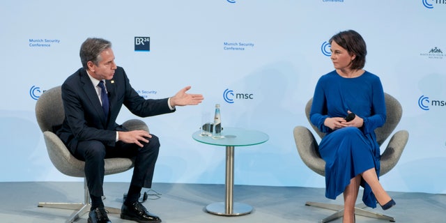 U.S. Secretary of State Antony Blinken, left, and German Foreign Minister Annalena Baerbock, right, attend a discussion during the Munich Security Conference in Munich, Germany, Friday, Feb. 18, 2022. 