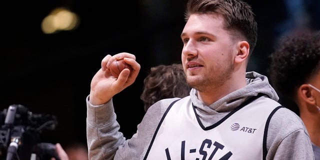 Dallas Mavericks forward Luka Doncic sets to throw a souvenir to fans during a practice session for the NBA All-Star basketball game in Cleveland, Saturday, Feb. 19, 2022.