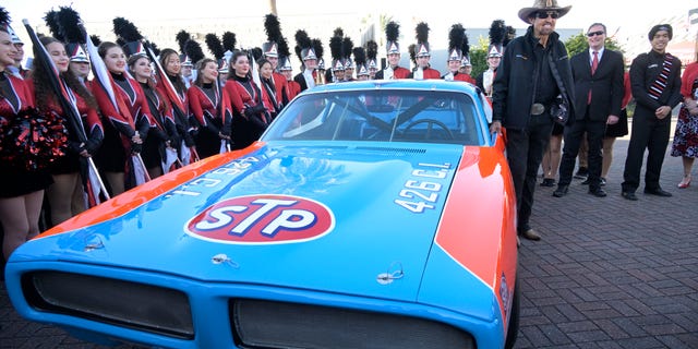 Richard Petty stands next to a replica race car before the NASCAR Daytona 500 auto race at Daytona International Speedway, Sunday, Feb. 20, 2022, in Daytona Beach, Fla. (AP Photo/Phelan M. Ebenhack)