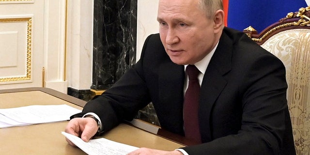 Russian President Vladimir Putin talks via videoconference with members of the Russian Paralympic Committee team on the eve of the XIII Paralympic Winter Games in Beijing, in Moscow, Russia, Monday, Feb. 21, 2022.
