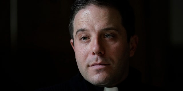 Father Matthew Hood is shown at Our Lady of the Rosary church Friday, Feb. 18, 2022, in Detroit. (AP Photo/Paul Sancya)