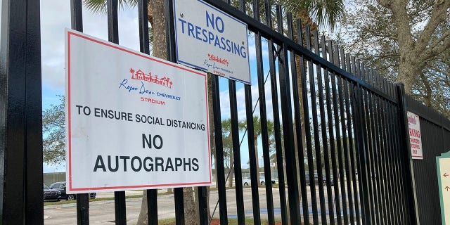 Signs are posted outside Roger Dean Stadium in Jupiter, Fla., Monday, Feb. 21, 2022. Baseball labor negotiations moved to the spring training ballpark from New York as players and owners join the talks, which enter a more intensive phase with perhaps a week left to salvage opening day on March 31.