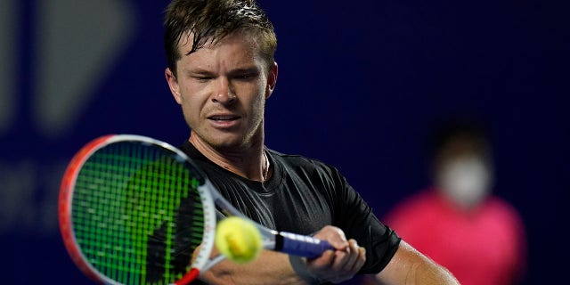 Stefan Kozlov, of the U.S., returns a ball during a match against Grigor Dimitrov, of Bulgaria, at the Mexican Open tennis tournament in Acapulco, Mexico, Monday, Feb. 21, 2022.