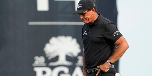 Phil Mickelson walks off the 14th green after missing a birdie putt during the third round at the PGA Championship golf tournament on the Ocean Course, Saturday, May 22, 2021, in Kiawah Island, South Carolina.