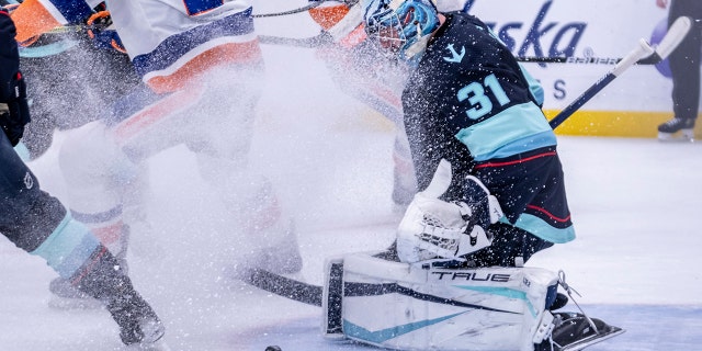 Seattle Kraken goalkeeper Philipp Grubauer makes a stop during the first period of the team's NHL hockey game against the New York Islanders, Tuesday, Feb. 22, 2022, in Seattle.