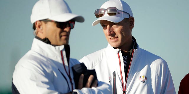 FILE - U.S. team captain Jim Furyk, right, stands alongside vice-captain Zach Johnson on the driving range at Le Golf National in Guyancourt, outside Paris, France, Tuesday, Sept. 25, 2018. The AP has learned Johnson has been selected as captain for the 2023 Ryder Cup in Italy.