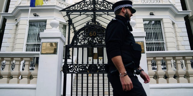 A police officer walks past the Ukrainian Embassy in west London, Thursday, Feb. 24, 2022, following Russia's attack on Ukraine.  World leaders expressed a raw outrage shrouded by an impotence to immediately come to the aid of Ukraine to avoid a major war in Europe, condemning Russia’s attack on its neighbor as the European Union and others promised unprecedented sanctions to hit the Kremlin. 