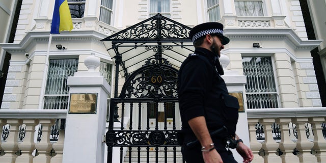 A police officer walks past the Ukrainian Embassy in west London, Thursday, Feb. 24, 2022, following Russia's attack on Ukraine. World leaders expressed a raw outrage shrouded by an impotence to immediately come to the aid of Ukraine to avoid a major war in Europe, condemning Russia’s attack on its neighbor as the European Union and others promised unprecedented sanctions to hit the Kremlin.