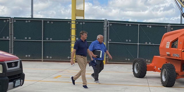 New York Yankees managing general partner Hal Steinbrenner, left, and San Diego Padres vice chairman Ron Fowler walk at Roger Dean Stadium in Jupiter, Fla., where baseball labor talks continue Thursday, Feb. 24, 2022.