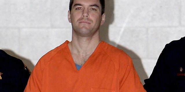 In this March 17, 2005, file photo, Scott Peterson is escorted by two San Mateo County Sheriff's deputies to a waiting van in Redwood City, Calif.