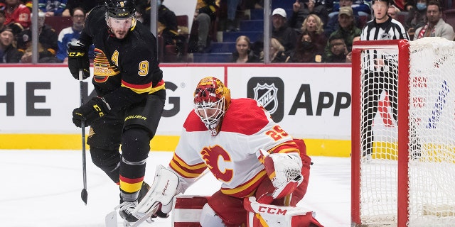 Vancouver Canucks' J.T. Miller (9) watches the rebound after Calgary Flames goalie Jacob Markstrom made a save during the third period of an NHL hockey game Thursday, Feb. 24, 2022, in Vancouver, British Columbia.