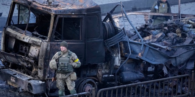 Ukrainian troops inspect a site following a Russian airstrike in Kyiv, Ukraine, Saturday, Feb. 26, 2022. 