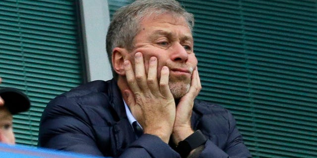 FILE - Chelsea soccer club owner Roman Abramovich sits in his box before their English Premier League soccer match against Sunderland at Stamford Bridge stadium in London, Dec. 19, 2015. Chelsea owner Roman Abramovich has on Saturday, Feb. 26, 2022 suddenly handed over the "stewardship and care" of the Premier League club to its charitable foundation trustees. The move came after a member of the British parliament called for the Russian billionaire to hand over the club in the wake of Russia’s invasion of Ukraine.