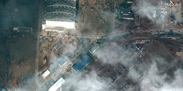 This satellite image provided by Maxar Technologies shows the aftermath of combat with grass fires and damage caused by recent airstrikes and heavy fighting with the Russians in and near the Antonov Airport, in Hostomel, Ukraine, Sunday, Feb. 27, 2022. (Satellite image ©2022 Maxar Technologies via WHD)