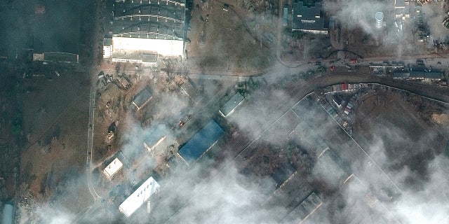 This satellite image provided by Maxar Technologies shows the aftermath of combat with grass fires and damage caused by recent airstrikes and heavy fighting with the Russians in and near the Antonov Airport, in Hostomel, Ukraine, Sunday, Feb. 27, 2022. (Satellite image ©2022 Maxar Technologies via WHD)