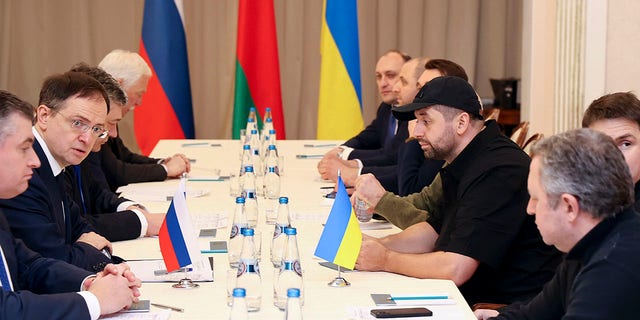 Vladimir Medinsky, head of the Russian delegation, second left, and Davyd Arakhamia, faction leader of the Servant of the People party in the Ukrainian Parliament, third right, attend the peace talks in Gomel region, Belarus, Monday, Feb. 28, 2022.