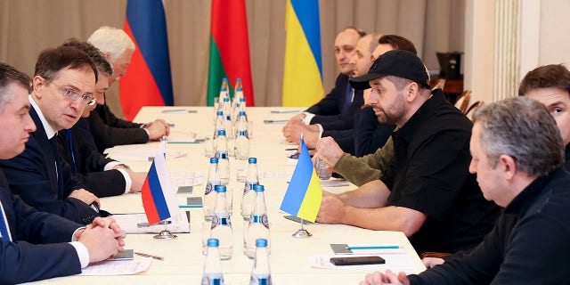 Vladimir Medinsky, head of the Russian delegation, second left, and Davyd Arakhamia, faction leader of the Servant of the People party in the Ukrainian Parliament, third right, attend the peace talks in Gomel region, Belarus, Monday, Feb. 28, 2022.