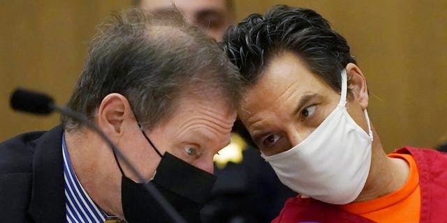 Scott Peterson, right, talks with attorney Cliff Gardner during a hearing at the San Mateo County Superior Court in Redwood City, Calif., Monday, Feb. 28, 2022. In 2004, Peterson was convicted of the murders of his wife, Laci Peterson, 27, who was eight months pregnant, and of the unborn son they planned to name Conner. 