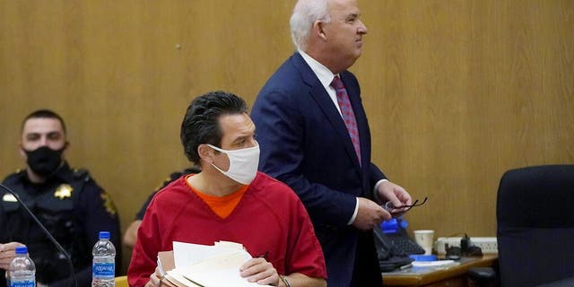 Scott Peterson, foreground, sits as his attorney, Pat Harris, walks behind him during a hearing at the San Mateo County Superior Court in Redwood City, Calif., Monday, Feb. 28, 2022. In 2004, Peterson was convicted of the murders of his wife, Laci Peterson, 27, who was eight months pregnant, and of the unborn son they planned to name Conner.