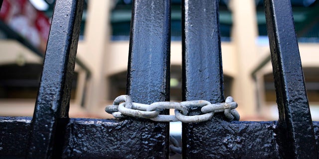 The gate to Roger Dean Stadium is locked as Major League Baseball negotiations continue in an attempt to reach an agreement to salvage March 31 openers and a 162-game season, Monday, Feb. 28, 2022, in Jupiter, Fla.