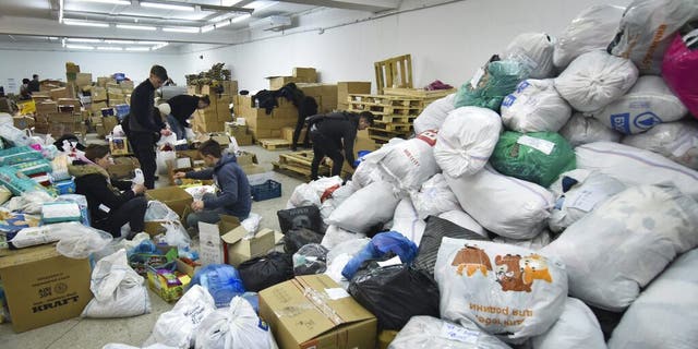 Volunteers prepare humanitarian aid for victims of the Russian invasion in Lviv, western Ukraine, Monday, Feb. 28, 2022. E