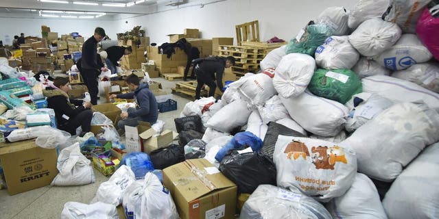Volunteers prepare humanitarian aid for victims of the Russian invasion in Lviv, western Ukraine, Monday, Feb. 28, 2022. E
