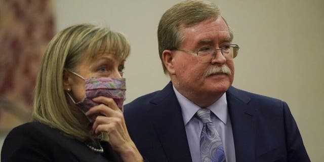 David Harris, right, and Birgit Fladager, both of the Stanislaus County District Attorney's office, stand during a break in a hearing at San Mateo County Superior Court in Redwood City, Calif., Monday, Feb. 28, 2022. 