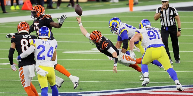 Joe Burrow #9 of the Cincinnati Bengals is sacked by Aaron Donald #99 of the Los Angeles Rams in the fourth quarter during Super Bowl LVI at SoFi Stadium on Feb. 13, 2022 in Inglewood, California.