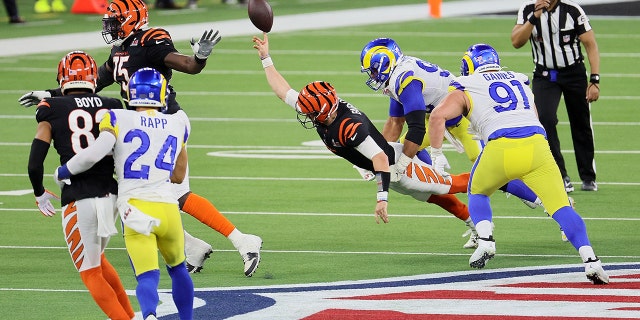 Joe Burrow #9 of the Cincinnati Bengals is sacked by Aaron Donald #99 of the Los Angeles Rams in the fourth quarter during Super Bowl LVI at SoFi Stadium on Feb. 13, 2022 in Inglewood, California.