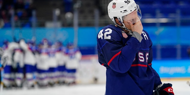 The United States' Aaron Ness (42) leaves the ice as Slovakia players celebrate behind him after a men's quarterfinal hockey game at the 2022 Winter Olympics Feb. 16, 2022, in Beijing. Slovakia won 3-2 in a shootout.