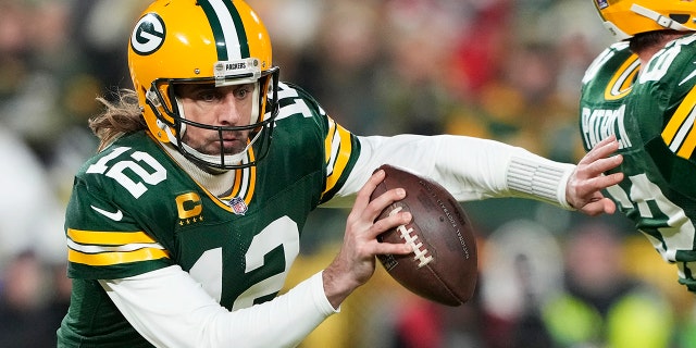 Quarterback Aaron Rodgers of the Green Bay Packers scrambles during the 1st quarter of an NFC divisional playoff game against the San Francisco 49ers at Lambeau Field Jan. 22, 2022, in Green Bay, Wis.