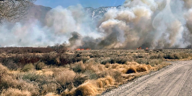 This photo provided by CAL FIRE San Bernardino Unit Public Information Office shows smoke and fire from a wildfire near in Owens Valley, Calif. on Thursday, Feb. 17, 2022. 