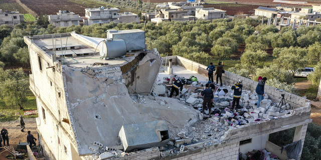 People inspect a destroyed house following an operation by the U.S. military in the Syrian village of Atmeh, in Idlib province, Syria, on Thursday.