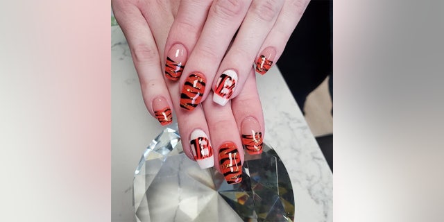 Ahead of her wedding day on Feb.  13, 2022, Rachel Hyden showed off her black-and-orange fingernails — Bengals-themed, of course.