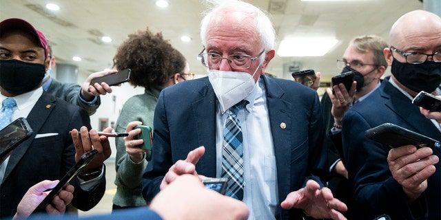 Sen. Bernie Sanders, I-Vt., speaks with reporters in the Senate subway, Dec. 13, 2021.
