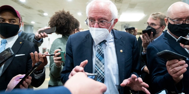 Sen. Bernie Sanders, I-Vt., speaks with reporters in the Senate subway on Monday, Dec. 13, 2021.