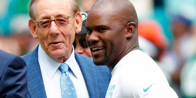 FILE -Miami Dolphins head coach Brian Flores talks to Miami Dolphins owner Stephen M. Ross during practice before an NFL football game against the New York Jets, Sunday, Nov. 3, 2019, in Miami Gardens, Fla.