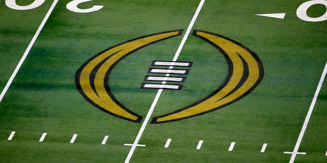 The College Football Playoff logo is shown on the field at AT&amp;T Stadium before an NCAA college football game in Arlington, Texas, Jan. 1, 2021.