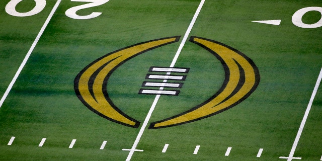 The College Football Playoff logo is displayed on the field of AT&T Stadium prior to an NCAA college football game in Arlington, Texas on January 1, 2021. The College Football Playoff will remain a format four teams through the 2025 season after postseason administrators failed to agree on an expansion plan before current contracts run out.  A person involved in the decision told The Associated Press on Friday, February 18, 2022, that the CFP's management committee, made up of 10 conference commissioners and Notre Dame's athletic director, met via video conference earlier this month. this week.